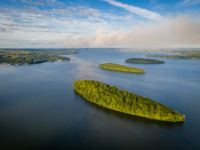 Drone view of 3 islands in Rice Lake on clear summer day